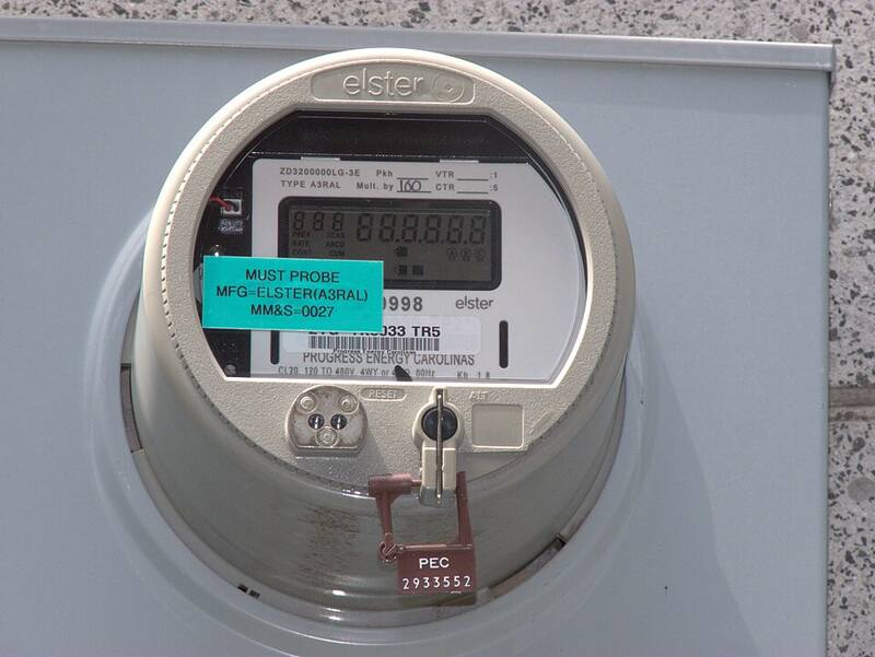 Digital electricity meter mounted on a wall