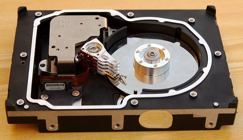 Inside of an opened hard disk drive showing the platters and read-write arm